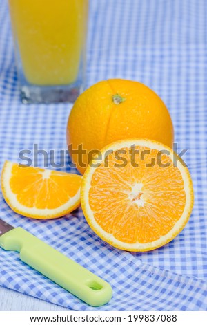 Oranges cut set and orange juice on table