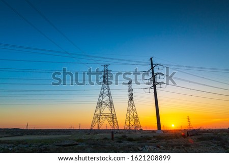 High voltage electric tower on sunrise time and sky on sunrise time background.Jubail highway-Saudi Arabia.