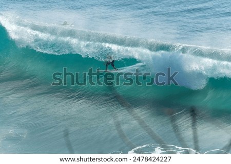 Image, Stock Photo Surfer at the beach carrying surfboard