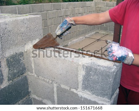 Hands holding bricklaying trowel, view close up