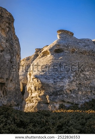 Similar – Foto Bild warm angestrahlter Felsen vor blauem Himmel