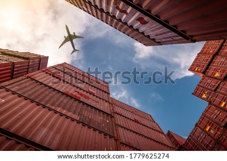 Airplane flying above container logistic. Cargo and shipping business. Container ship for import and export logistic. Logistic industry from port to port. Container at harbor for truck transport. 
