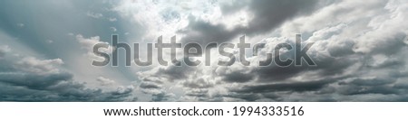 Panorama view of overcast sky. Dramatic gray sky and white clouds before rain in rainy season. Cloudy and moody sky. Storm sky. Cloudscape. Gloomy and moody background. Overcast clouds.