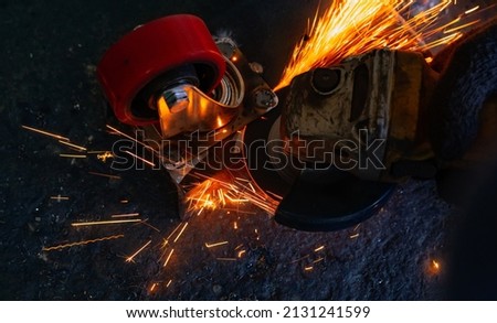 Similar – Image, Stock Photo Industrial worker using angle grinder grinding metal on welding seams. Worker working with angle grinder and has sparks. Tool for cut steel. Safety in industrial workplace. Metal factory industry.