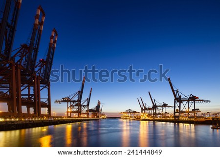 A large container harbor with deep blue night sky, taken with a shift lens