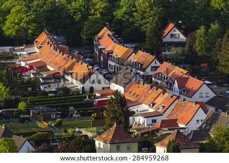 High angle view of a little west German village with red roofs and large gardens near Aachen.