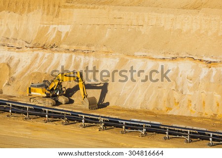 A small excavator at parked in a lignite pit mine