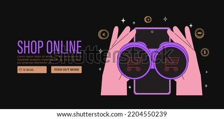 Hands hold binoculars with shooping cart search presents, gifts online in store or shop through mobile application on smartphone. Concept of sale, discount for web or socila media banner. Black friday