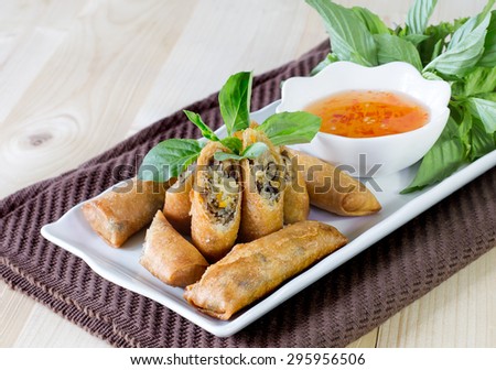 Veg Spring Rolls, on white dish and wooden table