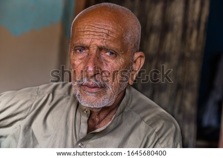 Similar – Image, Stock Photo Portrait of very old farmer with straw hat explaining life in front of a red tractor.