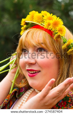 Cheeked Russian cheerful young woman in a wreath of fresh dandelion, flirt, flirty look, surprise, emotion,