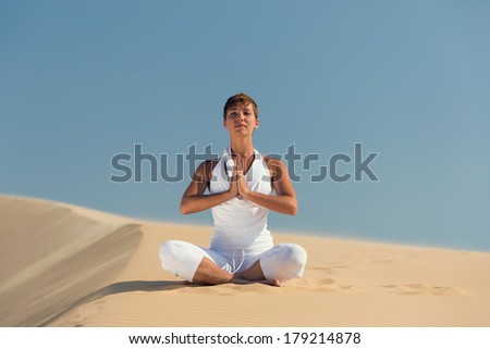 Yoga meditation on the beach, healthy female body in peace, woman sitting relaxed on sand over beautiful sea sunset, calm girl enjoying nature, active vacation lifestyle, zen spa, wellness concept