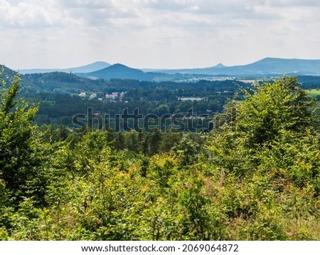 Panoramic view from sandstone rock viewpoint Havrani skaly, spring landscape in Lusatian Mountains , green hills, fresh deciduous and spruce tree forest. Blue sky background, copy space Stock foto © 