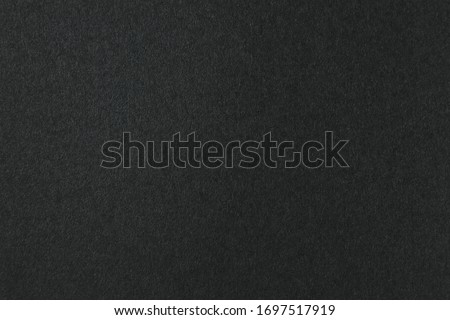 Deep black color of a blank sheet of paper with gradient. Gloomy background for text and design.