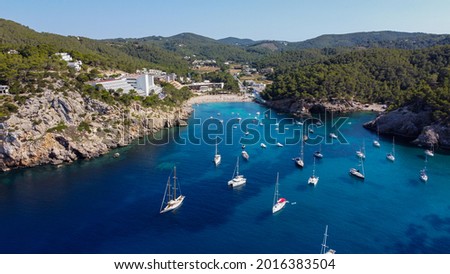 Aerial view of the beach of Port Sant Miquel on the north shore of Ibiza island in Spain - Isolated bay sided with large hillside hotels in the Balearic Islands Photo stock © 