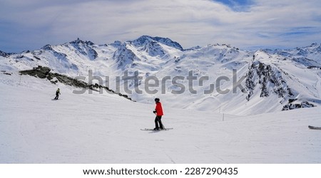 Similar – Image, Stock Photo Skier with red jacket and green backpack in icy snowy landscape walks on lonely ski track on way to mountain in evening light