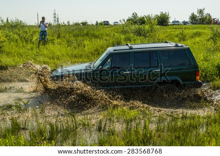Lvov, Ukraine - May 30, 2015: Off-road vehicle Jeep Cherokee  overcomes the track on  of   landfill near the city  Lvov, Ukraine.