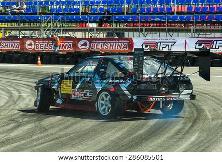 Lvov, Ukraine - June 6, 2015: Unknown rider on the car brand Ford overcomes the track in the championship of Ukraine drifting in Lvov, Ukraine.