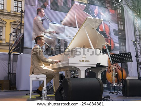 Lvov, Ukraine - 25 June 2015: Alfa Jazz Fest 2015. Antony Strong playing piano on stage jazz festival on the Market Square in Lvov near the town hall.