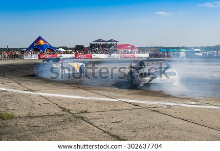 Vinnytsia,Ukraine-July 25, 2015: Unknown riders  on the cars  brand  Nissan overcomes the track in the  Drift championship of Ukraine  on July 25,2015 in Vinnytsia, Ukraine.