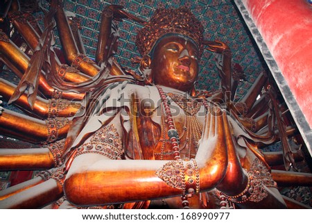 Chengde, China - August 1, 2009: The gigantic statue of Guanyin in Puning temple covered with dust on August 1, 2009. This is one of the largest wooden statues on Earth.