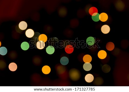 Colorful small spots of blurred light in dark background, horizontal