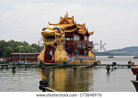 Hangzhou, China - July 08, 2007: Large dragon boats packed with tourists cruise the waters of the famous West Lake, Hangzhou, Zheijang Province on July 08,2007.