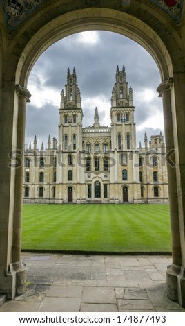 Oxford, England - July 11, 2010: Entrance to a college in Oxford showing spacy courtyard and ornamental spires with dark clouds in background on July 11, 2010.