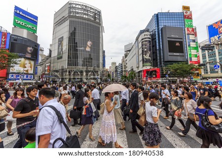 Tokyo, Japan - June 26, 2010: Wideangle photo of the crowds of people at Shibuya Crossing on a cloudy day on 26 June 2010. Shibuya is probably the best known meeting place in Tokyo.