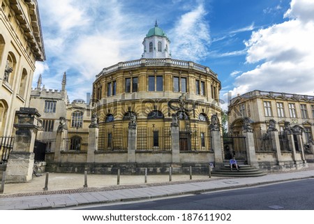 Oxford, England - July 10, 2010. A student sits on the stairs in front of the Sheldonian Theatre on July 10, 2010. Sheldonian theatre is one of the most important landmarks of Oxford.
