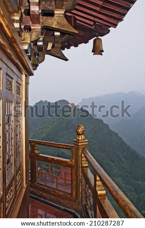 photo of golden chinese pagoda with a view to green mountains stylized and filtered to look like an oil painting. Location - Jiuhua Shan, Anhui province.