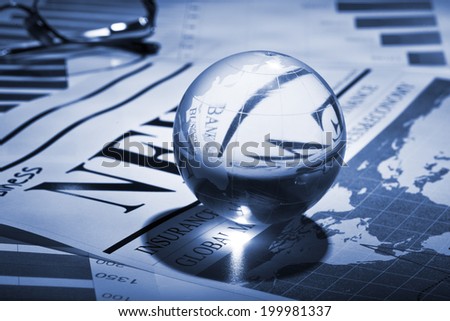 Globe on business documents with deep shadow tinted in blue.