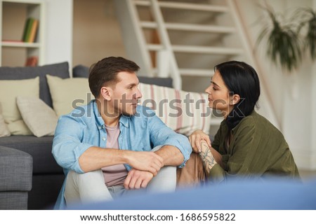 Similar – Image, Stock Photo Young happy couple staying at home with their baby son sitting on the living room floor.