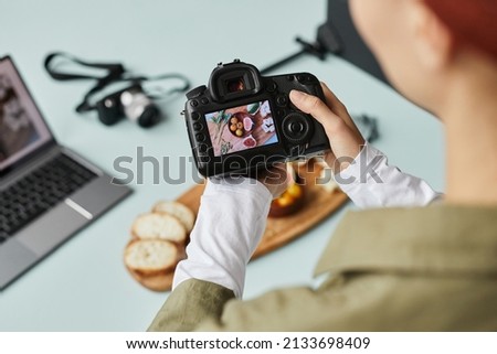 Image, Stock Photo Female photographer working on photos on laptop and camera
