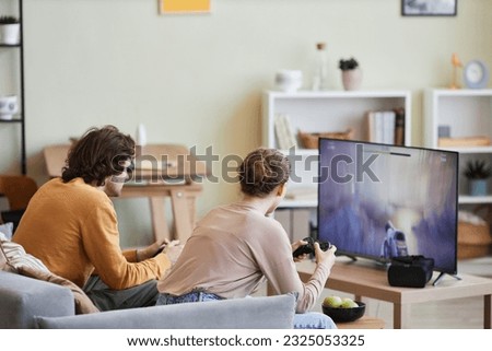 Similar – Image, Stock Photo Young couple playing with their soon at home.