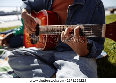 Similar – Image, Stock Photo Anonymous black man playing synthesizer while female watching in recording studio