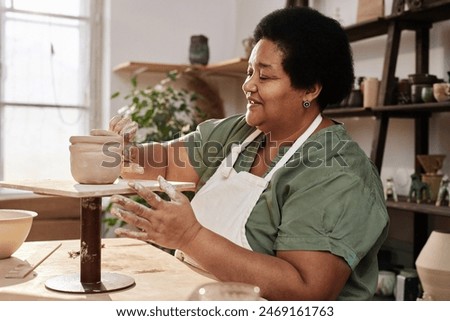 Similar – Image, Stock Photo Female artisan working with paints in workshop