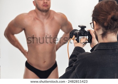 Similar – Image, Stock Photo Unrecognizable photographer taking photo on camera near wall outdoors