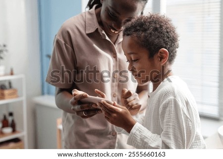 Similar – Image, Stock Photo Little Boy watching Mother on the phone