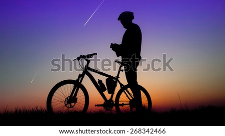 Mountain bike, silhouette of biker and sunshine
