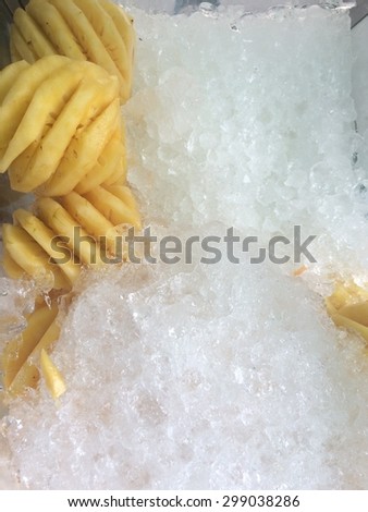 close up of pineapple on ice box for sale