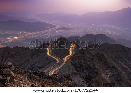 Traffic light trails wrapped around mountain on the zig zag road in Al Hada, Taif region of Saudi Arabia