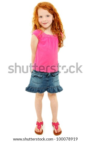 Beautiful young elementary age school girl over white with long curly red hair in summer clothes.