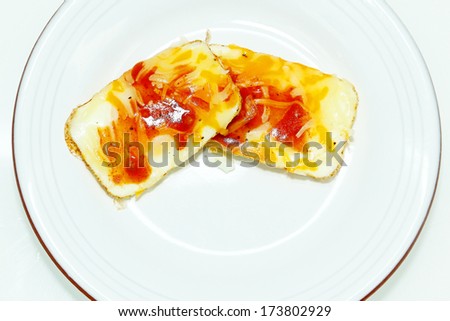 Eggs Baked in Muffin Tin with Salsa and Cheese in Plate