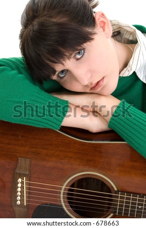 Young woman with acoustic guitar. Green sweater, black hair, blue eyes. Shot in studio over white.