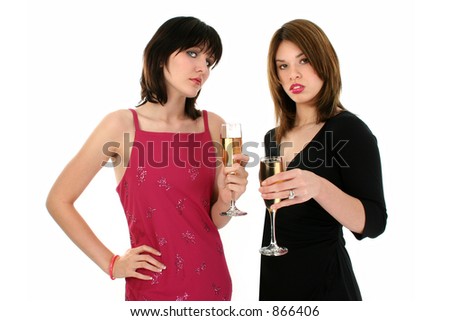 Upper body shot of two girls drinking champagne at a party.