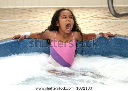 Young girl decides the hot tub is TOO hot.