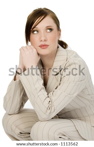 Beautiful young business woman in beige suit.  Shot in studio over white.
