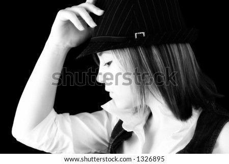 Beautiful 20 year old woman in pin stripped hat. Profile, close-up in black and white.