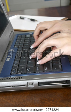 Woman\'s hands with typing on laptop computer keyboard.